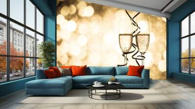 two champagne glasses with ribbons against holiday lights and fireworks - New Year celebrations Wall mural