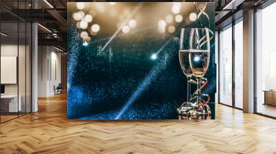 two glasses of champagne in the spotlight - new year celebration Wall mural