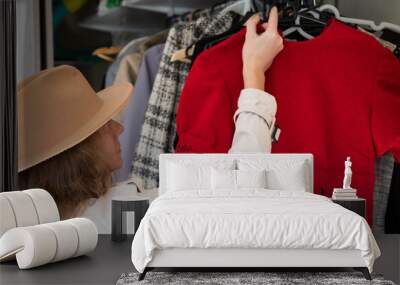 woman buying second hand clothes Wall mural