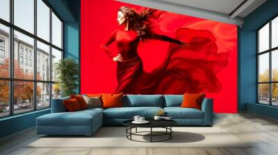 woman in long red dress dancing on red background Wall mural