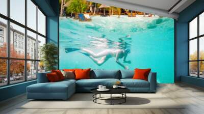 woman snorkeling in clear tropical waters - active holiday Wall mural