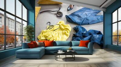 yellow and blue pieces of clothes on the floor woman undressing Wall mural