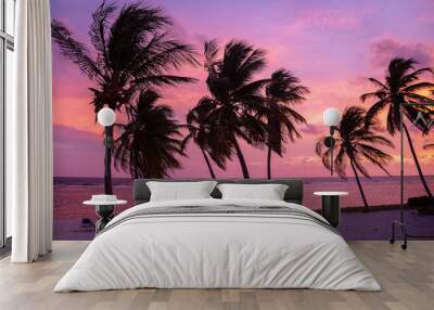 Tropical pink and purple sunset over ocean Wall mural