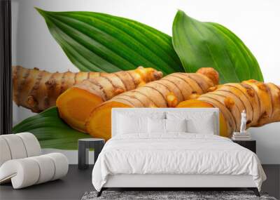 Turmeric (Curcuma longa Linn) rhizome (root) sliced with green leaves isolated on white background Wall mural