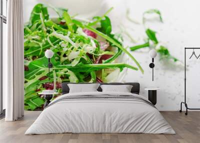 Salad from fresh herbs, arugula, lettuce, salt and sesame in white bowl. Vegetarian, dietary dish Wall mural