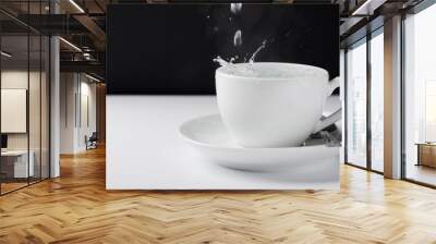 White mug for tea on a white table with pouring hot water. Wall mural