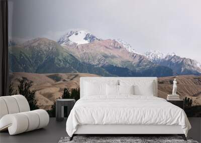 Beautiful landscape with yellow hills and snow capped mountains, Issyk Kul region, Kyrgyzstan Wall mural