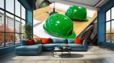 Hard hats on the wooden table. Green hard hats. Wall mural