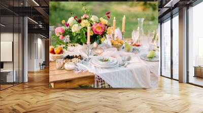 women's day, wedding, celebration, romance, picnic, nature concept - gorgeous table setting with snow white tablecloth, dishes, clear wine-glasses, silver candleholders and various fruits Wall mural