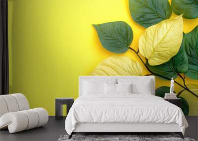 Colorful yellow and black leaves on yellow background with copy space.  Wall mural