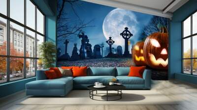 Spooky halloween background with pumpkins skulls at a cemetery graveyard Wall mural