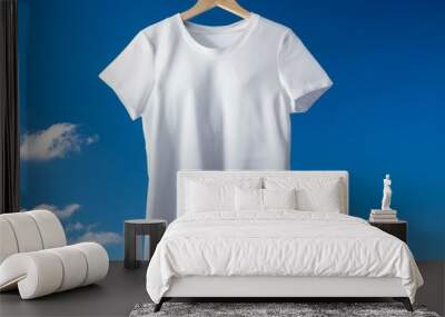 Washed white t-shirt on blue sky background Wall mural