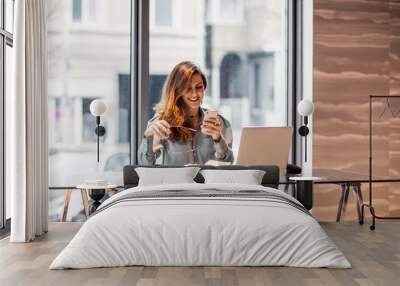 Businesswoman working on a laptop Wall mural