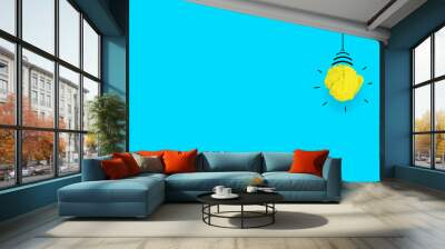 innovation concept, crumpled paper on blue background and bright idea lamp around Wall mural