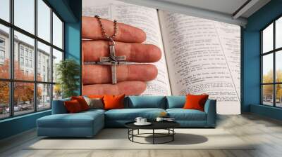 holy bible open with a cross on a hand Wall mural