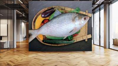 fresh hilsa fish on a wooden board with vegetable  Wall mural