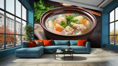 Asian style chicken soup filled with potatoes carrot and onion served in a white bowl - 2 Wall mural