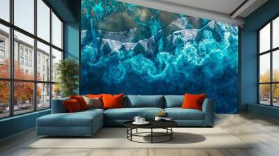 An aerial view of a vast body of fluid, with wind waves creating a pattern on the electric blue water, along with underwater reefs supporting marine biology  Wall mural