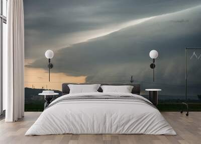 An ominous looking shelf cloud of a severe thunderstorm is approaching the city of Targu Mures in Transylvania, Romania Wall mural