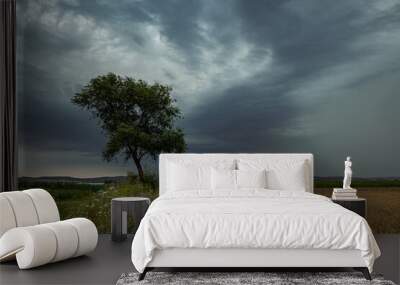 Dramatic landscape image of a tree with lightning storm in the background Wall mural