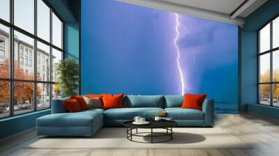 Long bright lightning strike over sea Wall mural