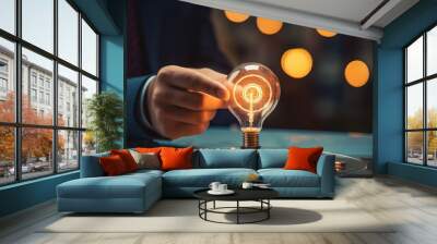 Businessman holding glowing light bulb, innovation and creative idea concept Wall mural