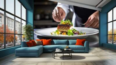 Chef decorating fish with fresh vegetables on white plate in restaurant kitchen Wall mural