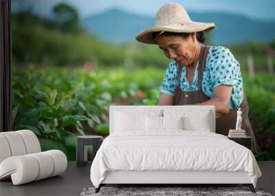 Farmer examining crops in organic vegetable garden, concept of sustainable agriculture, healthy food production and self sufficiency Wall mural