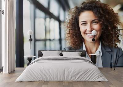 Portrait of beautiful young businesswoman smiling at camera while standing in office Wall mural