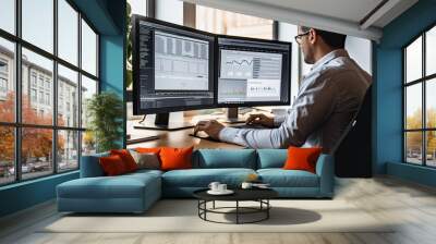 rear view of trader using computer with charts on screen in office Wall mural