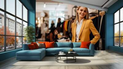 Woman trying on a yellow blazer in a clothing store Wall mural