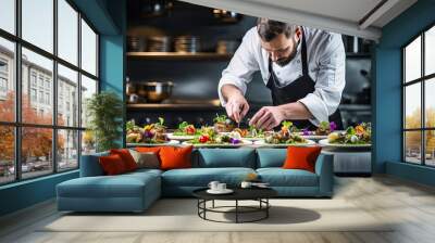 young male chef decorating vegetable salad in modern kitchen at hotel or restaurant Wall mural