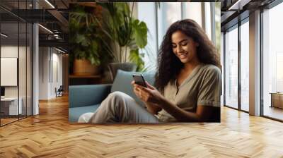 happy young woman with smartphone at home in the living room Wall mural