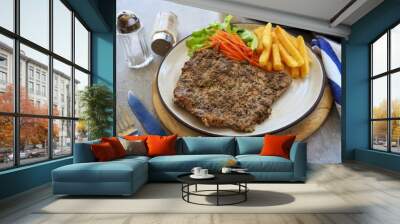 Pepper Pork Steak in white plate on grey background Wall mural