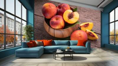 Yellow Peach with slice in wooden basket, Fresh Yellow Peach fruit in wooden bowl on wooden background. Wall mural