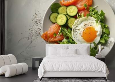 Breakfast plate featuring a salted salmon salad accompanied by fresh greens cucumbers a fried egg and bread with copy space image Wall mural