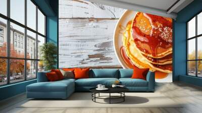 Close-up of delicious homemade caramel stuffed pancakes on a white wooden background with selective focus, top view, and spacious area for text or images - a great copy space image. Wall mural