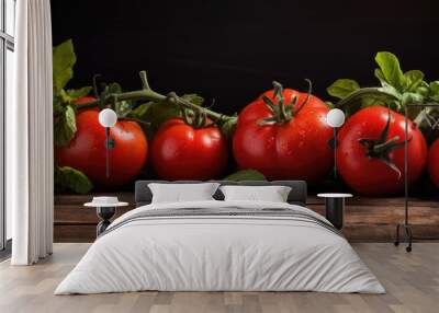 vegetarian food concept with fresh tomatoes on vine and green basil on a black rustic wooden backdro Wall mural