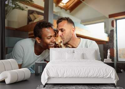 Beautiful gay couple cuddling their dogs, enjoying their morning at home - Multi-ethnic couple living in a beautiful modern house made of wood, metal and glass. Wall mural