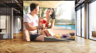 People drinking a cocktail next to a swimming pool Wall mural