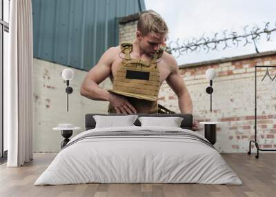 Strong athlete wearing a weighted vest to better exercise Wall mural