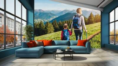 Family hiking concept. Family with children in the forest. They walk through the forest enjoying the smell of nature and the view of mountains Wall mural