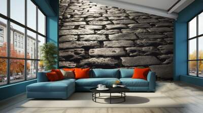 Black cobbled stone road background with reflection of light seen on the road. Black or dark grey stone pavement texture. Wall mural