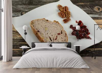 Slice of cranberry walnut bread with nuts and dried cranberries on table Wall mural