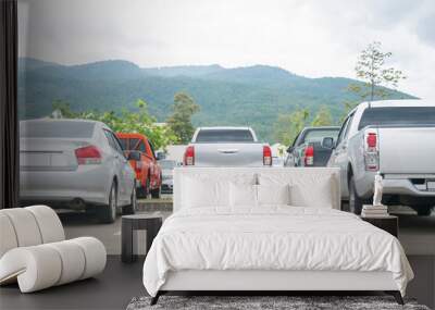 Car parked in asphalt parking lot and empty space for car park in nature with trees and mountain background .Outdoor parking lot Wall mural