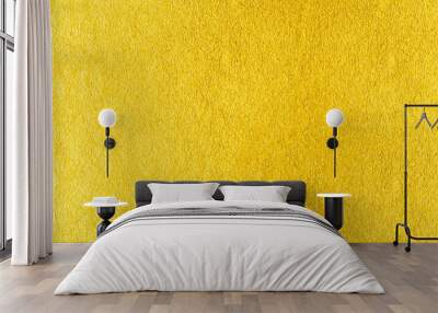 Gold wall texture background. Yellow shiny gold foil paint on wall surface with light reflection, vibrant golden luxury wallpaper Wall mural