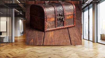 closed treasure chest standing on wooden table Wall mural