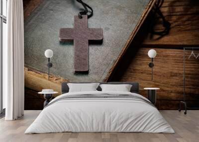 Closeup of wooden Christian cross on bible Wall mural