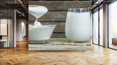 Glass cup of Turkish traditional drink ayran , kefir or buttermilk made from yogurt, homemade yoghurt in glass bowl on rustic table, healthy food Wall mural