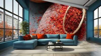 Heap of dried saffron spice in spoon on rustic background, spices and herbs concept (Crocus sativus) Wall mural